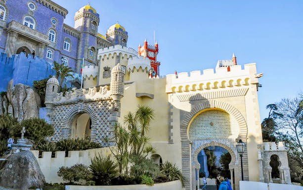Pena Palace entrance in Sintra, Portugal, showcasing colorful architecture on a full-day tour from Lisbon.