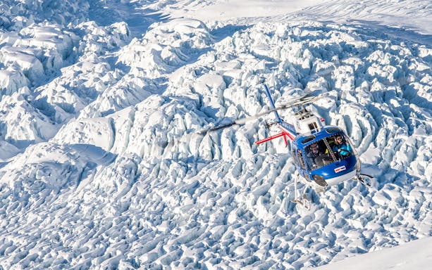 Helicopter flying over Franz Josef Glacier during Neve Discoverer Tour.