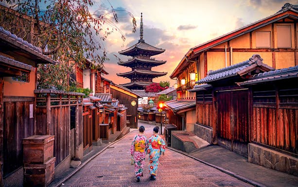 Traditional street in Kyoto with pagoda and people in kimonos, part of Kyoto Osaka Sightseeing Pass.