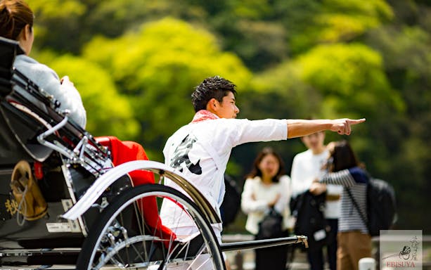 Rickshaw ride through bamboo grove in Arashiyama, Kyoto, Japan.