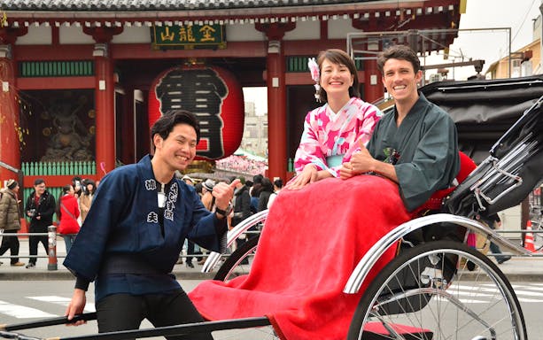 Rickshaw ride in Asakusa, Tokyo with Senso-ji Temple in the background.
