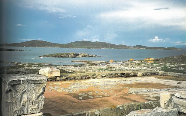 Ancient ruins of Delos with sea view, seen from Mykonos tour.