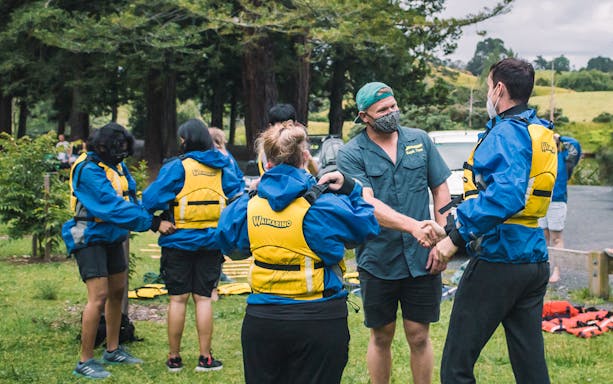 Participants preparing for Big Kanu Glowworm tour in Tauranga, wearing life jackets.
