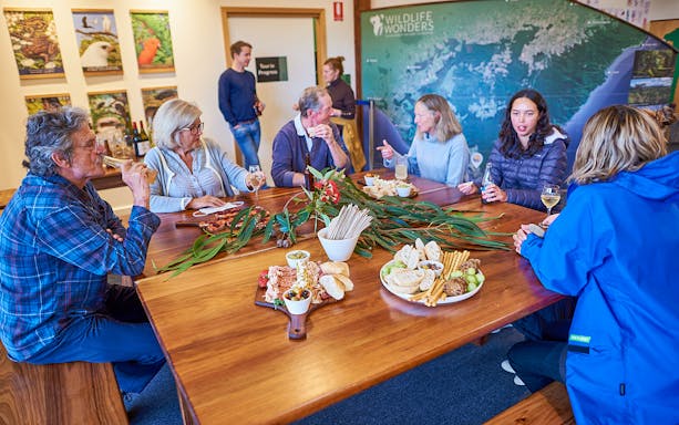 Guests enjoying snacks and drinks at a table during the Dusk Discovery Tour.