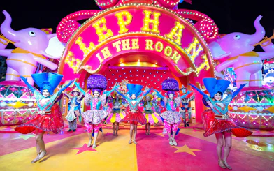 Performers in colorful costumes at Carnival Magic Phuket, Thailand.