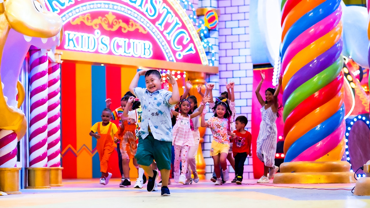 Desfile Carnival Magic Phuket con vibrantes carrozas y artistas, traslado opcional disponible.