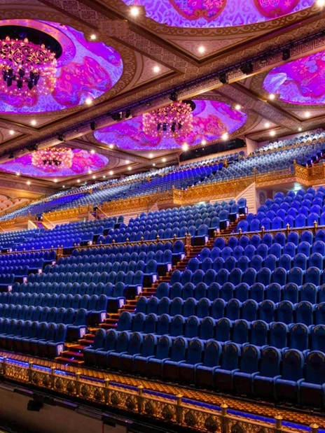 Grand theater seating at Carnival Magic Park in Phuket with ornate ceiling and chandeliers.