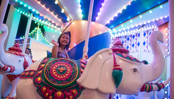 Carnival Magic Park entrance in Phuket with vibrant lights and decorations, dinner and transfer options available.