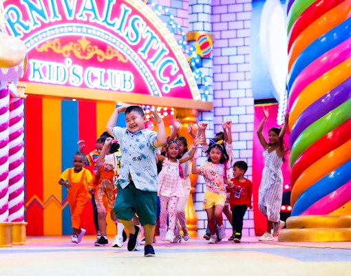 Carnival Magic Park in Phuket, vibrant parade with performers in colorful costumes, dinner experience.