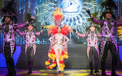 Performers in vibrant costumes on stage at Alcazar Cabaret Show, Pattaya.