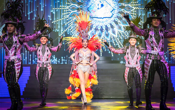 Performers in vibrant costumes on stage at Alcazar Cabaret Show, Pattaya.