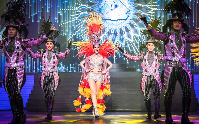 Performers in vibrant costumes on stage at Alcazar Cabaret Show, Pattaya.