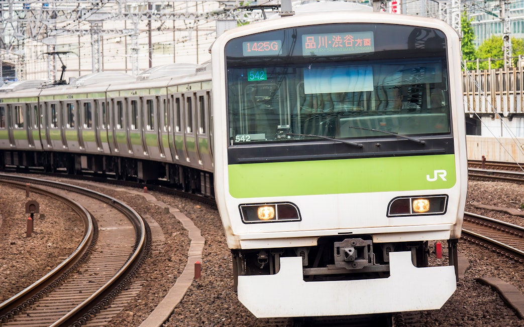 JR train on tracks in Shikoku, Japan, part of the JR All Shikoku Rail Pass experience.