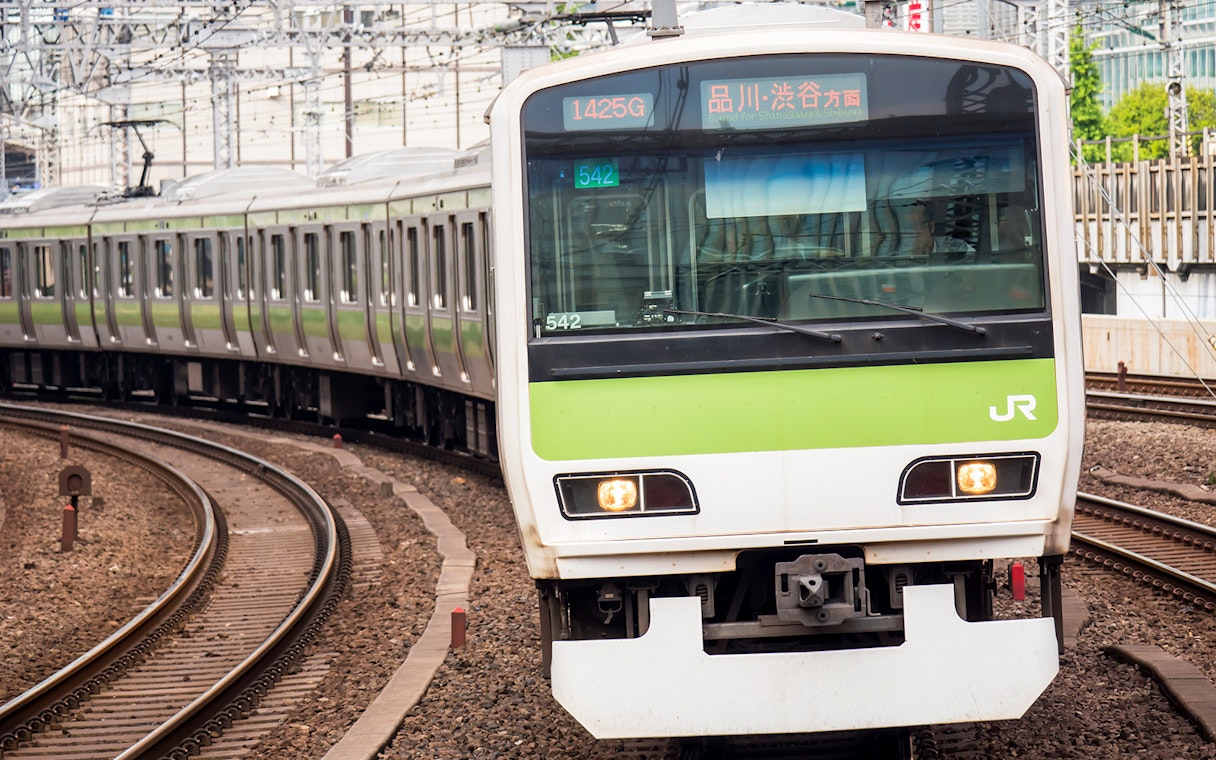JR train on tracks in Shikoku, Japan, part of the JR All Shikoku Rail Pass experience.