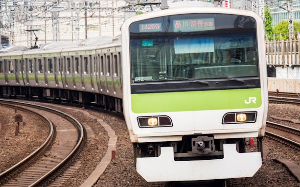 JR train on tracks in Shikoku, Japan, part of the JR All Shikoku Rail Pass experience.