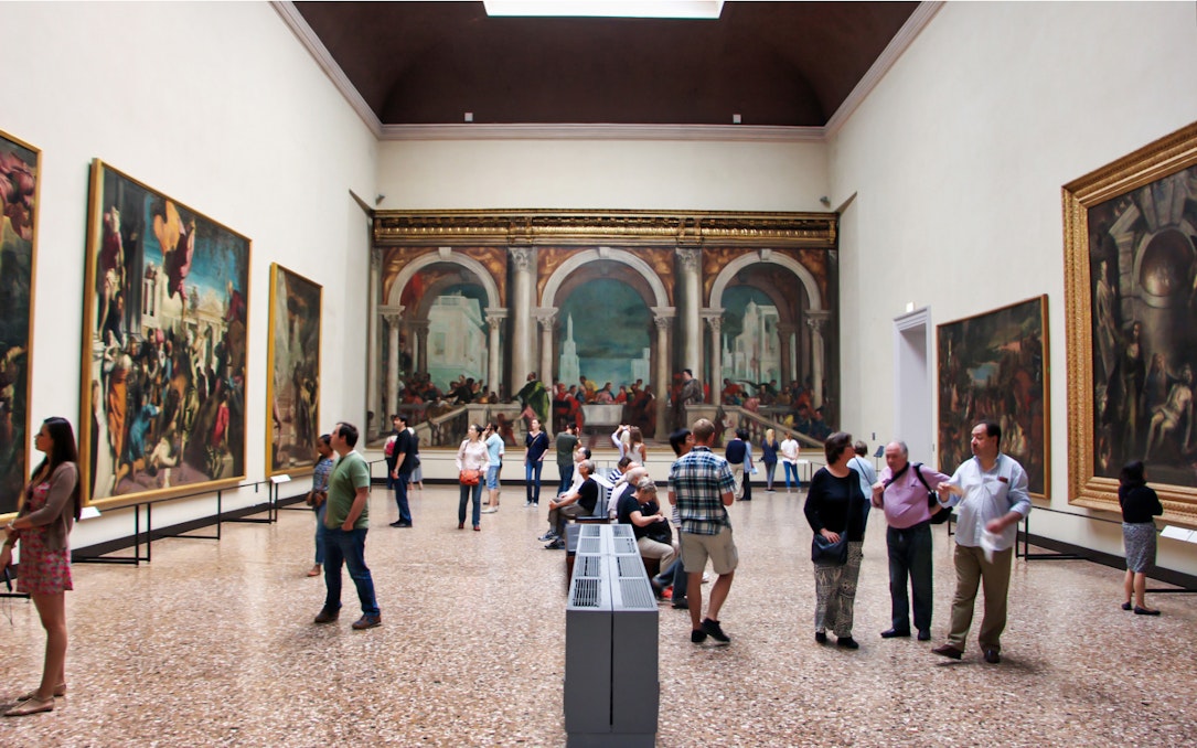 Visitors viewing paintings in Accademia Gallery, Florence.