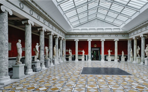 Accademia Gallery interior with classical statues and marble columns, Florence.