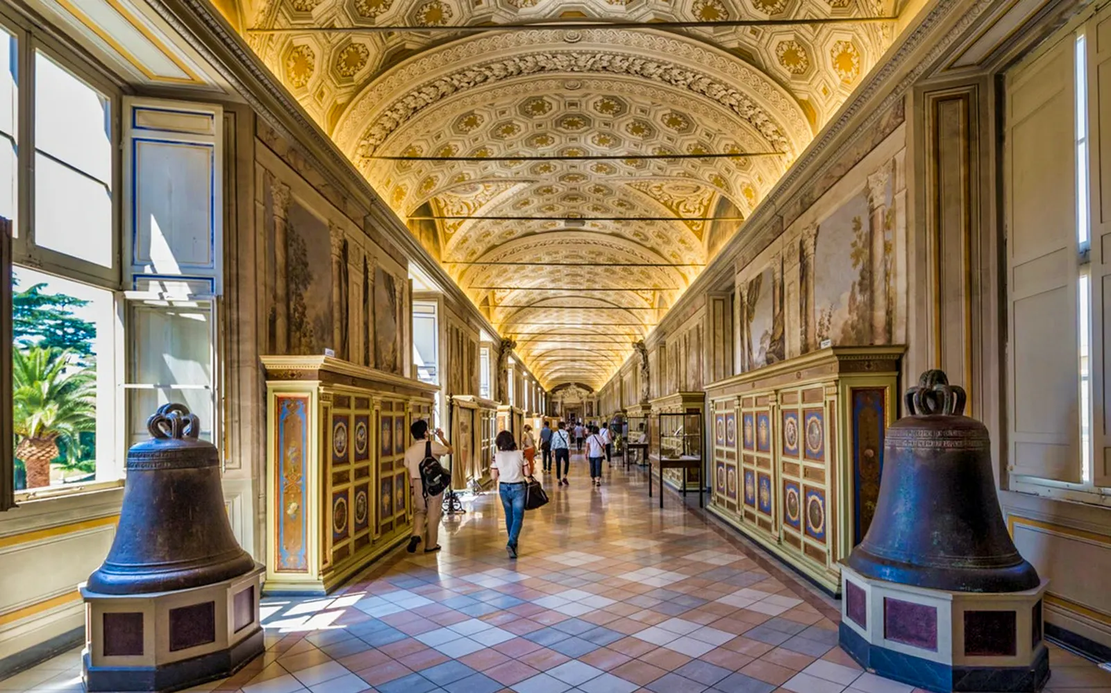 Vatican Museums ornate hallway with visitors, part of guided tour in Rome.