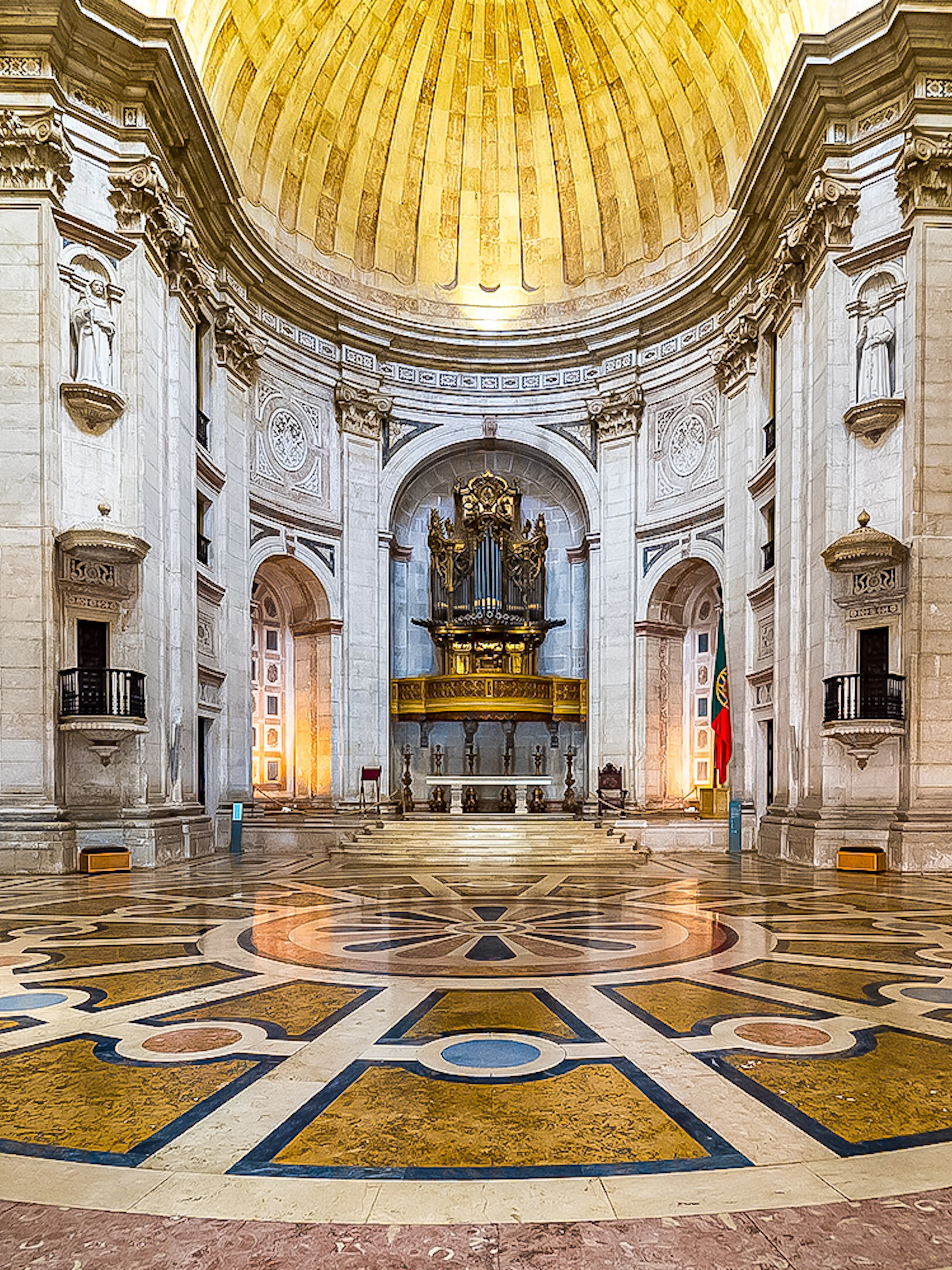 Interior of the National Pantheon in Lisbon with ornate dome and grand organ.