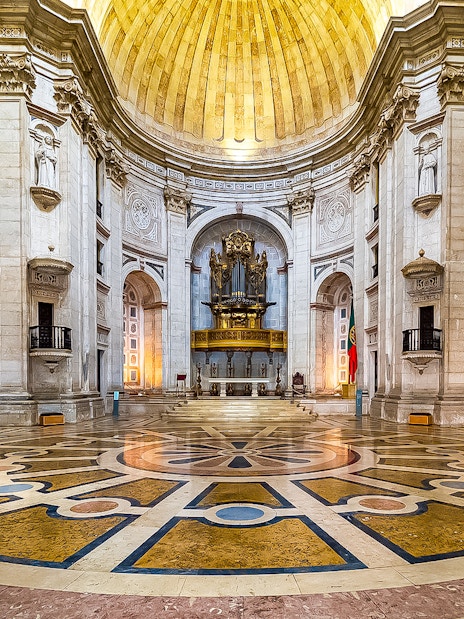 Interior of the National Pantheon in Lisbon with ornate dome and grand organ.