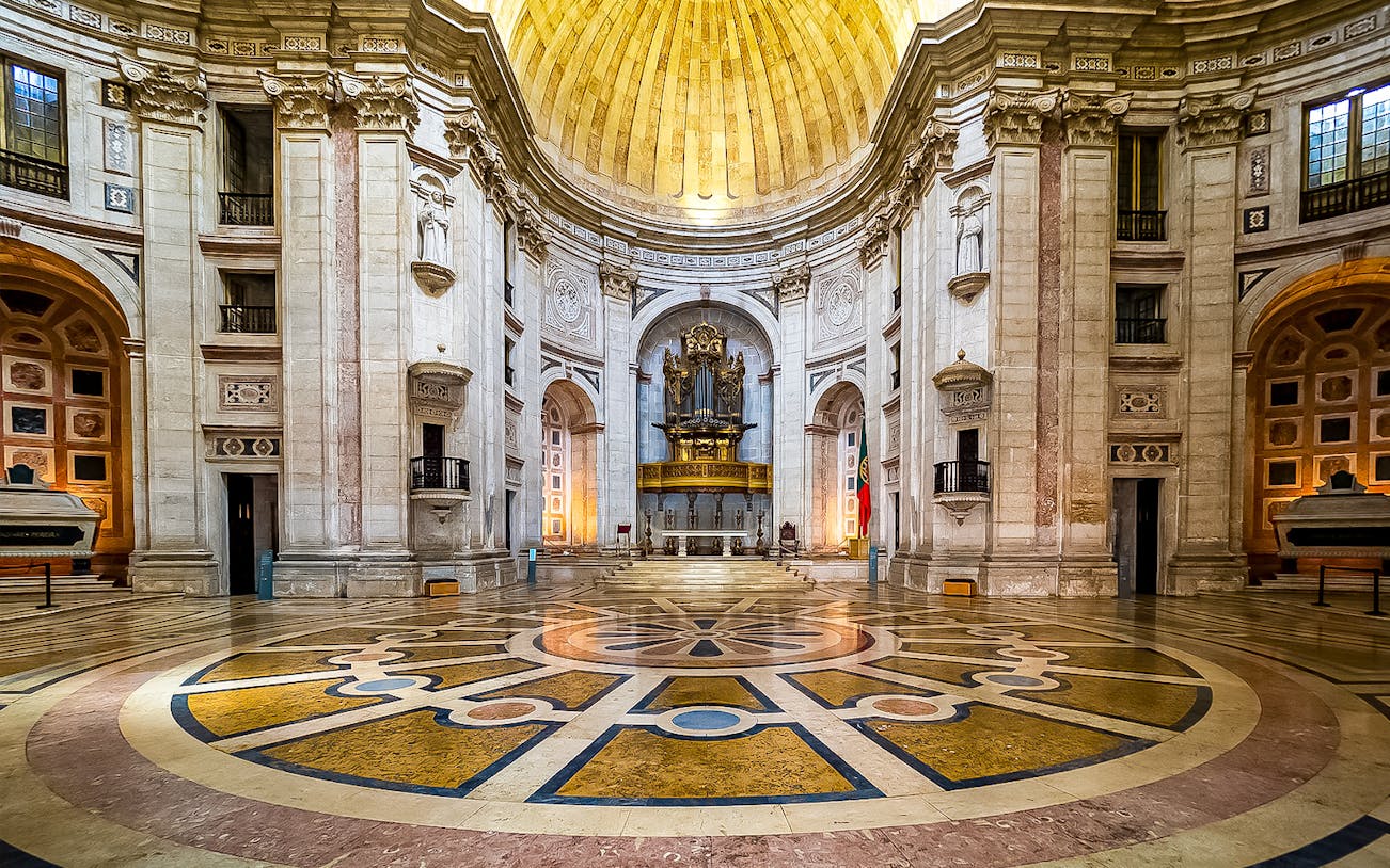 Interior of the National Pantheon in Lisbon with ornate dome and grand organ.