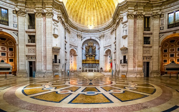 Interior of the National Pantheon in Lisbon with ornate dome and grand organ.