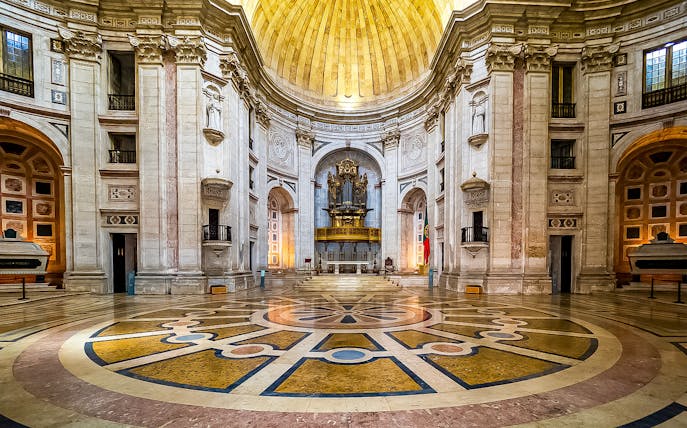 Interior of the National Pantheon in Lisbon with ornate dome and grand organ.