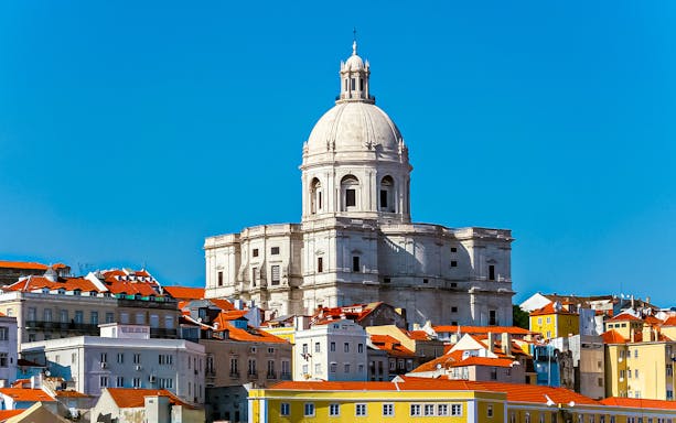 National Pantheon in Lisbon with colorful buildings in the foreground.