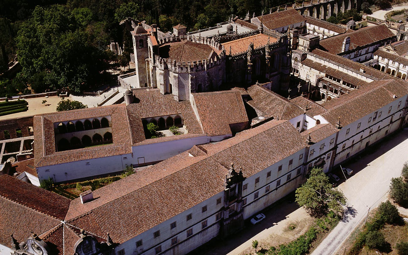 Aerial view of the Convent of Christ in Lisbon, showcasing its historic architecture and surrounding gardens.