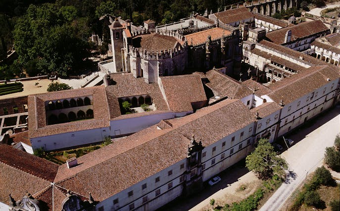 Aerial view of the Convent of Christ in Lisbon, showcasing its historic architecture and surrounding gardens.