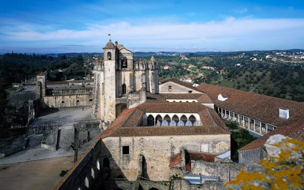 Convent of Christ in Lisbon with historic architecture and surrounding landscape.