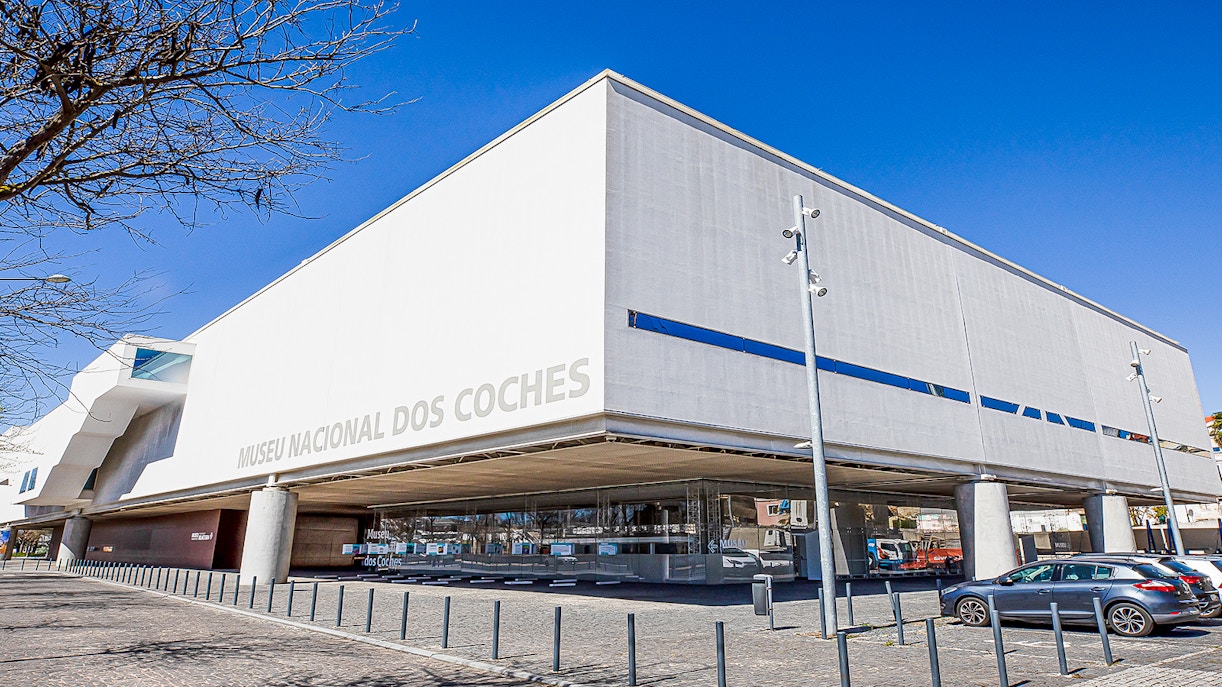 Visitors exploring the National Coach Museum in Lisbon, showcasing historical carriages and artifacts
