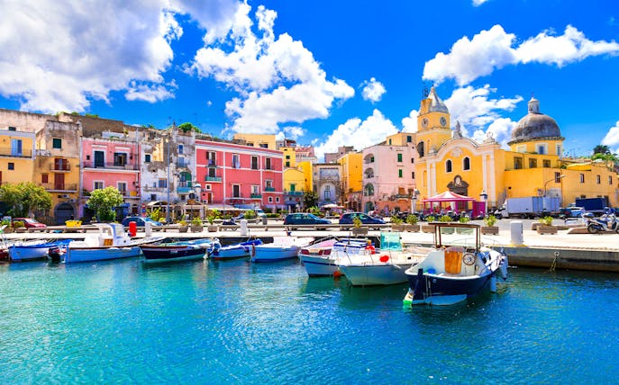 Colorful buildings and boats at the harbor of Procida Island, Italy.