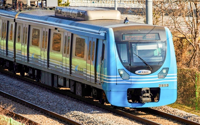 AREX train traveling between Incheon Airport and Seoul on a sunny day.