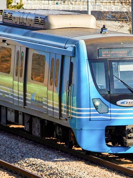 AREX train traveling between Incheon Airport and Seoul on a sunny day.