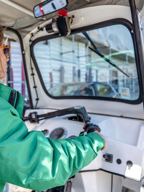 Tuk-tuk driver navigating Lisbon streets along the 28 tram route.