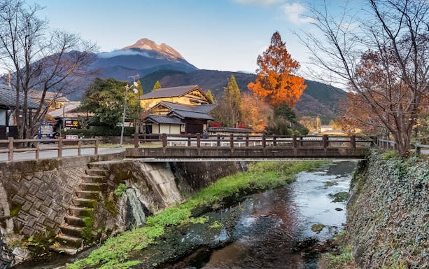 Japanese village with a bridge over a stream, mountains in the background, Sugoca IC Card region.