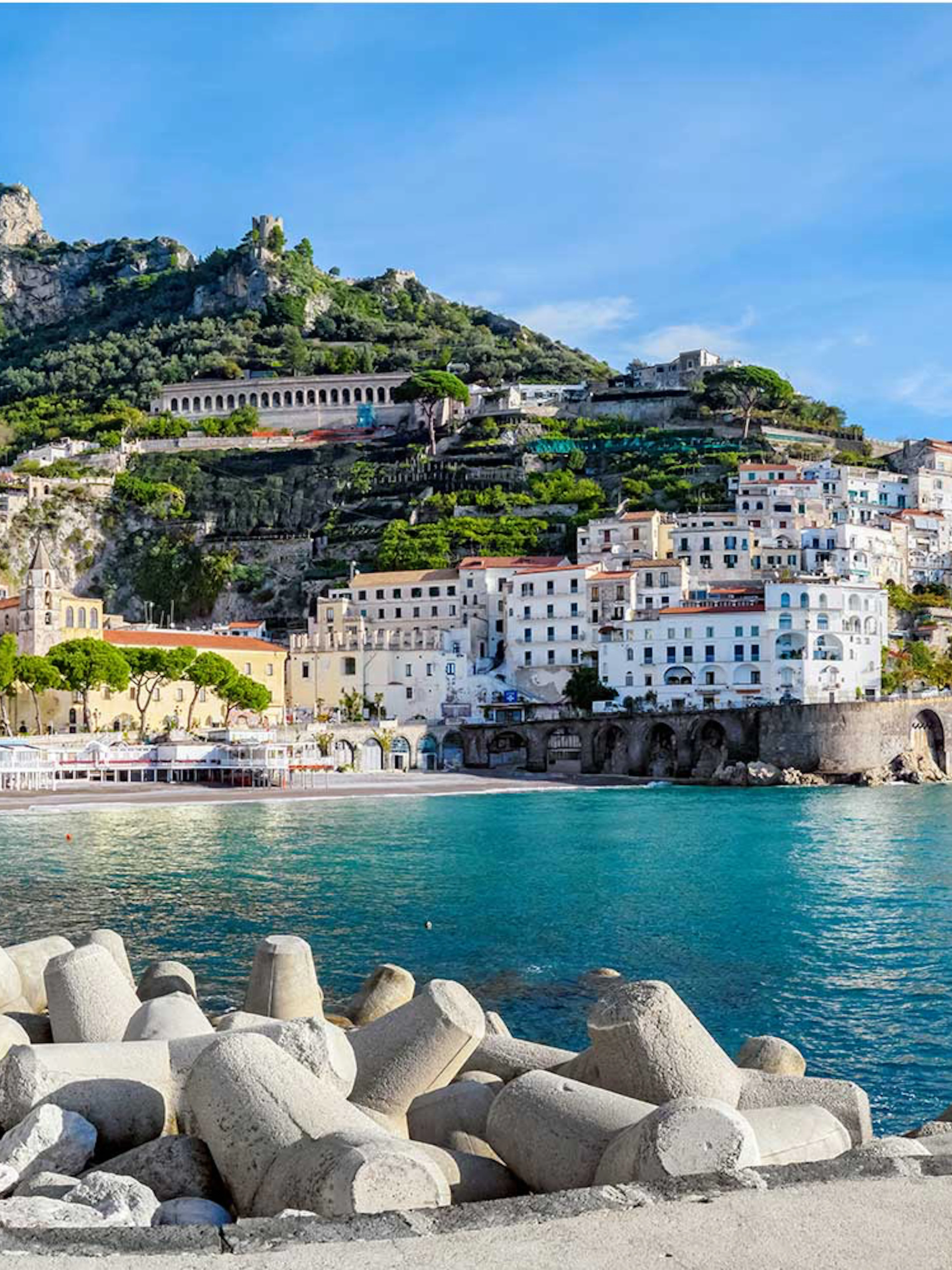 Amalfi Coastline with colorful buildings and cliffs viewed from the sea.