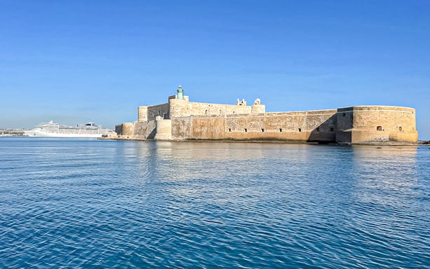 Fort Saint-Nicolas with cruise ship in Marseille, France, viewed from the water.