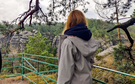 Visitor overlooking rock formations in Bohemian Switzerland National Park.