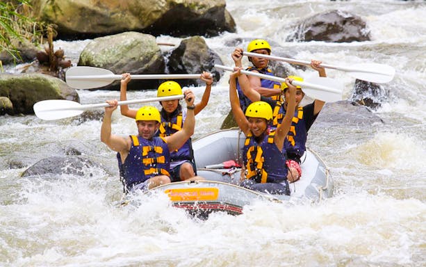 White water rafting group on Ayung River with Mason Adventures, navigating rapids.