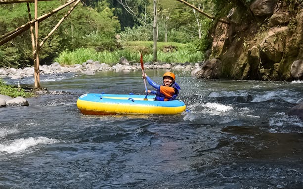 Rafters navigating rapids on Telaga Waja River, Bali, during a white water rafting tour by BTR.