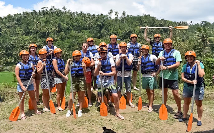 Group of rafters with paddles ready for white water rafting on Telaga Waja River, Bali.