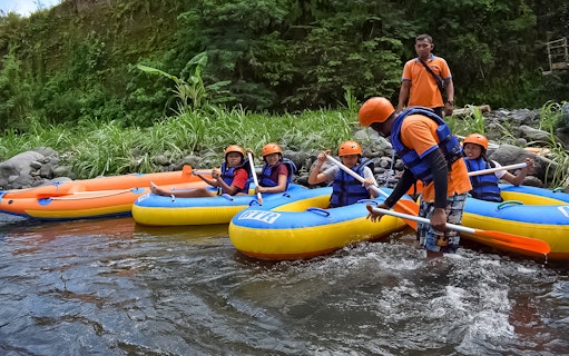 White water rafting group on Telaga Waja River with guide, BTR rafts.
