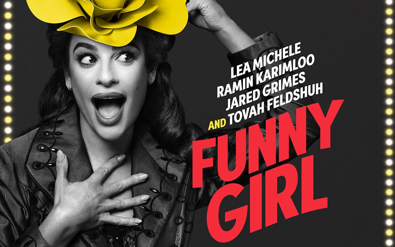 Performer in costume with a yellow hat for "Funny Girl" show.