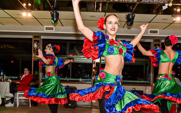 Dancers performing on a Bosphorus dinner cruise with vibrant costumes.