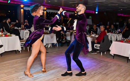 Dancers performing on a Bosphorus dinner cruise with private tables.