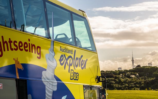 Auckland Explorer Bus with Sky Tower in the background.