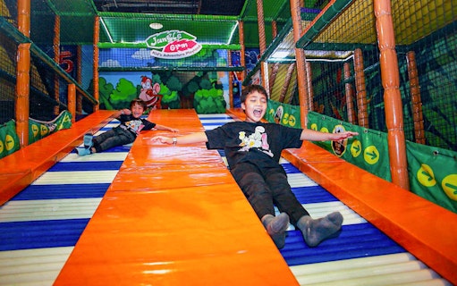 Children sliding at Jungle Gym, Kuala Lumpur indoor playground.