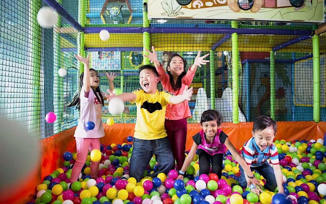 Children playing in a colorful ball pit at Jungle Gym, Kuala Lumpur.